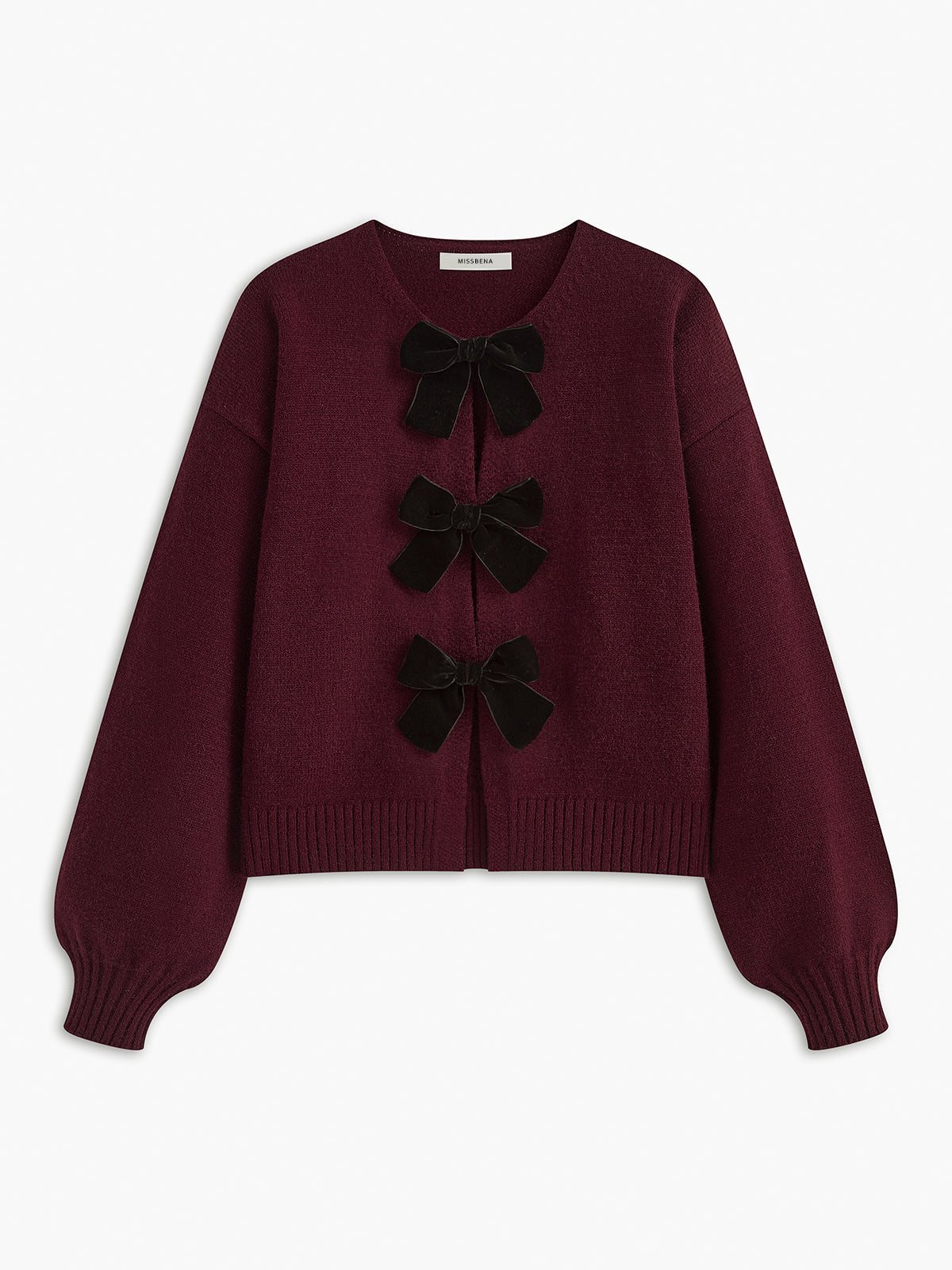 Sweter z ozdobnymi kokardkami na guziki