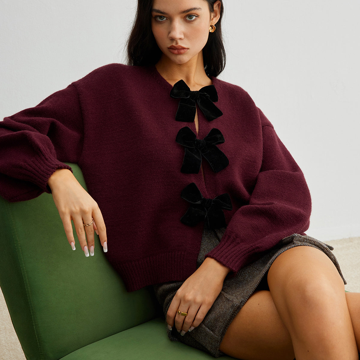Sweter z ozdobnymi kokardkami na guziki